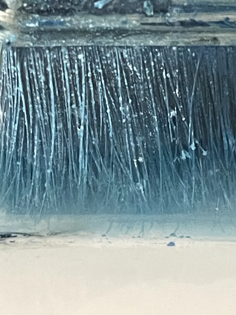 Gros plan sur une brosse chargée de bleu