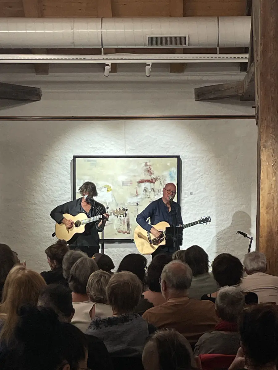Deux guitaristes au milieu des œuvres